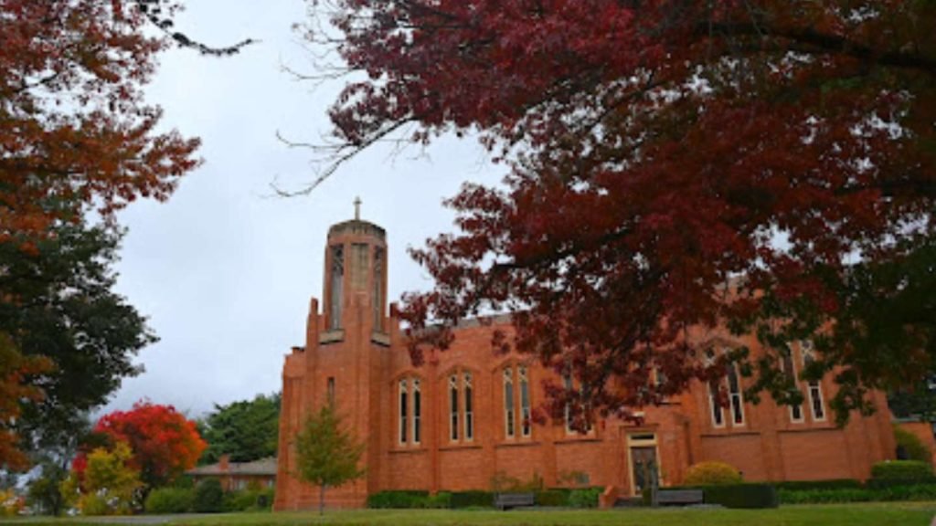 Roof Repairs Canberra restoring a tall brick church in Forrest, Canberra